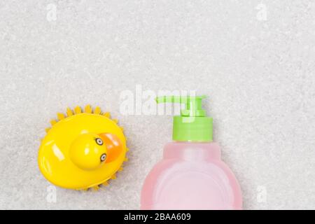 Plastic bootle of liquid soap shampoo with dispenser and brush, closeup, on white background. Free space. Washing hands. Stock Photo
