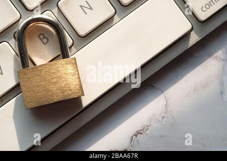 Cyber safety concept, locked and key on laptop computer keyboard. Stock Photo