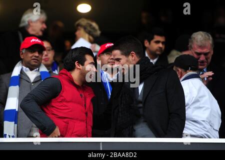 QPR vice-chairman Amit Bhatia (left) chats with Jamie Redknapp (right) in the stands Stock Photo