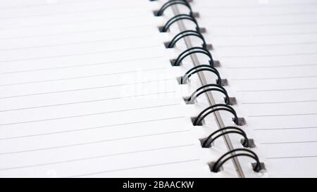 Close up of  lines notebook or spiral notepad paper background. Stock Photo