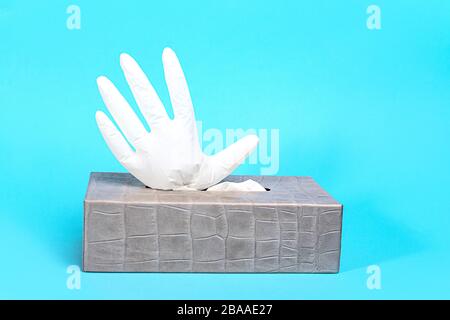 Concept of prevention from coronavirus with rubber latex gloves on blue background. Outbreak of coronavirus COVID-19 concept. Novel coronavirus - 2019-nCoV. Stock Photo