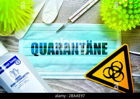 PHOTOMONTAGE, mask with the stroke quarantine, biology danger sign, protective gloves, clinical thermometers and disinfectants on a table, symbolic ph Stock Photo