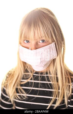 young girl in a face mask on a white background Stock Photo