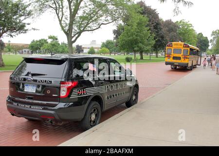 Dearborn Police Department vehicle and school bus outside the Henry Ford Museum, Dearborn, Michigan, USA Stock Photo