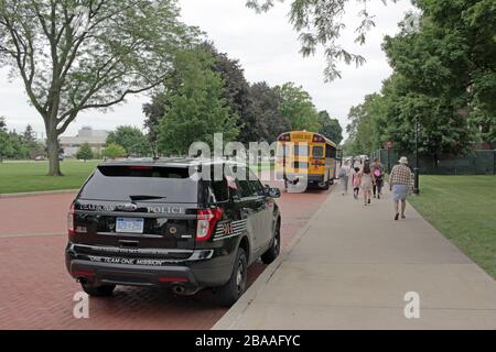 Dearborn Police Department vehicle and school bus outside the Henry Ford Museum, Dearborn, Michigan, USA Stock Photo