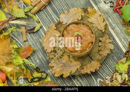 Apple jam in wooden bowl and fresh apples. Apple marmalade in wooden bowl. Stock Photo