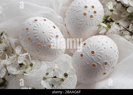 Three white Easter eggs decorated with wax, close up Stock Photo