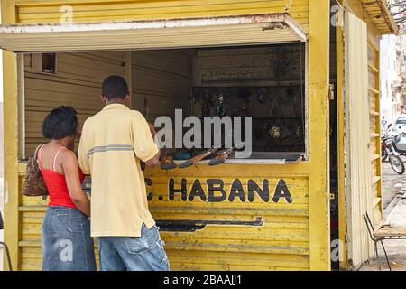 Young cuban couple having fun at shooting gallery stall in Centro Havana Stock Photo