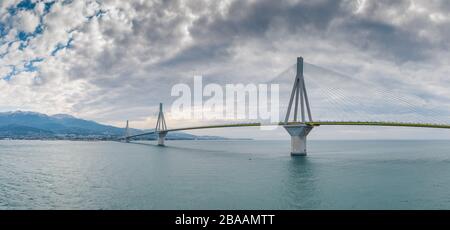 Aerial view of long cable-stayed Rio bridge in Greece at clouds weather, Ferry station Stock Photo