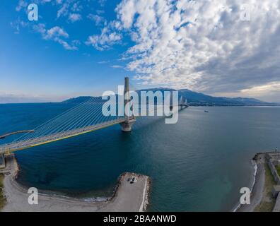 Aerial view of long cable-stayed Rio bridge in Greece at clouds weather, Ferry station Stock Photo