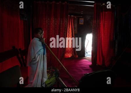 Africa, Ethiopia, Adadi Mariam.  Religious procession in Adadi Mariam. A young devote holds a cane Stock Photo