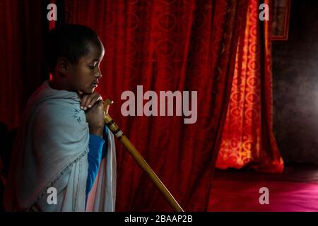 Africa, Ethiopia, Adadi Mariam.  Religious procession in Adadi Mariam. A young devote holds a cane Stock Photo