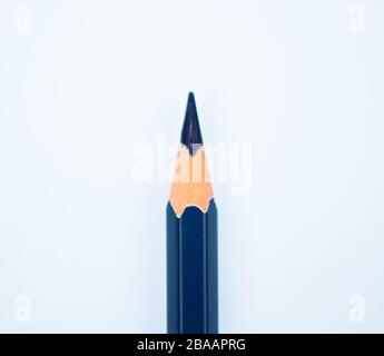 Close up picture of a nicely sharpened blue colored wood pencil crayon before a white background Stock Photo
