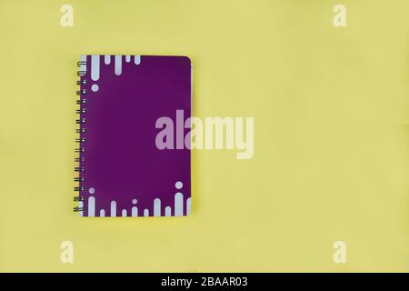 Top view of an purple note book diary with white stripes before an isolated white background Stock Photo