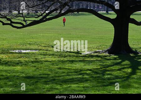 New York City, USA. 26th Mar, 2020. A person chooses to cross an empty Sheep's Meadow in Central Park, in New York, NY, March 26, 2020. New York State is seeing the highest number of cases in the United States, with (as of this writing) more than 37,000 tested positive cases of COVID-19 and more than 21,000 in New York City. (Anthony Behar/Sipa USA) Credit: Sipa USA/Alamy Live News Stock Photo