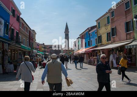 Burano / Venice / Italy - April 17, 2019: Tourists shopping in a market, Burano