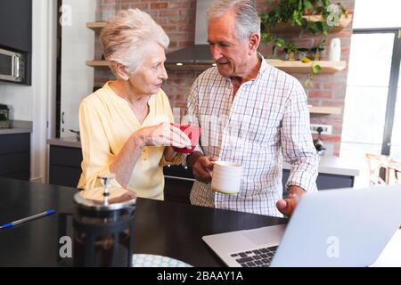 Caucasian senior couple using laptop at home Stock Photo