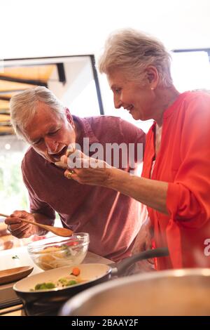 Caucasian senior couple cooking together at home Stock Photo