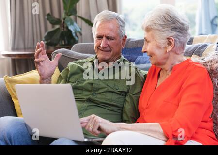 Caucasian senior couple using laptop at home Stock Photo