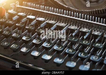 Keyboard of a retro typewriter, illuminated by sunlight Stock Photo