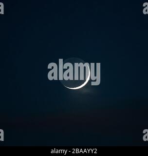 London, UK. 26th March 2020. Waxing crescent moon with a 4% sunlit edge, the main disk is lit by earthshine, reflected sunlight from planet Earth. Credit: Malcolm Park/Alamy Live News. Stock Photo