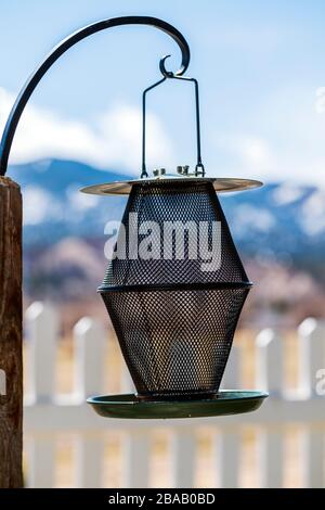 Exterior view of empty metal bird feeder Stock Photo