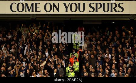 West Ham United fans (right) separated by police officers are taunted by Tottenham Hotspur fans after conceding a goal Stock Photo