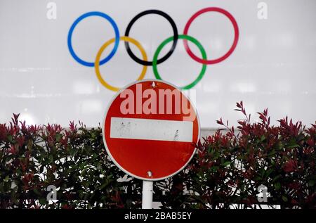 March 24, 2020, Tokyo, Japan: A do no entry traffic sign next to a Tokyo Government Building with a huge Tokyo 2020 Olympic banner, on Tuesday. Today, the International Olympic Committee on recommendations from WHO (World Health Organization), the IOC President Bach and the Prime Minister of Japan S. Abe have postponed the 2020 Tokyo Summer Games of the XXXII Olympiad. Rescheduled to a date beyond 2020 but not later than summer 2021, to safeguard the health of the athletes, everybody involved in the Olympic Games and the international community. (Credit Image: © Ramiro Agustin Vargas Tabares/Z Stock Photo