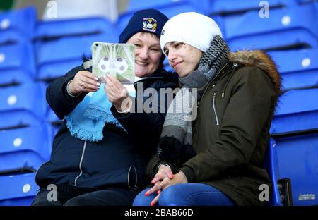 Coventry City fans take a selfie in the stands prior to the beginning of the match Stock Photo