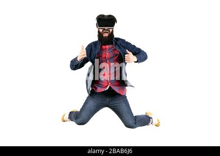 jumping hipster in glasses of virtual reality showing thumb up, isolated on white background Stock Photo