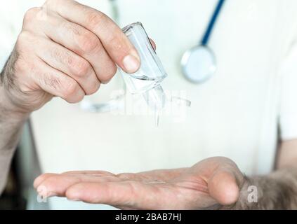 Alcohol gel on hand. Sanitizer for hand disinfection, against bacteria and coronavirus. Stock Photo