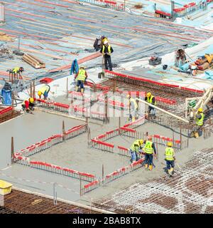Hamburg, Germany; 20th May 2019; Group of Construction Workers at Work on a Large Construction Site Stock Photo