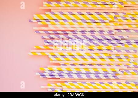 Drinking paper colorful straws for summer cocktails on light pastel background with copy space. Eco friendly Reusable Straws. Paper cocktail tubes Stock Photo