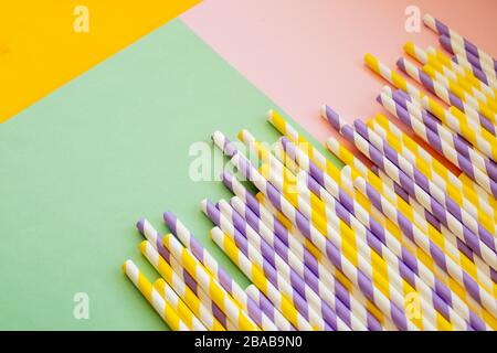 Drinking paper colorful straws for summer cocktails on light pastel background with copy space. Eco friendly Reusable Straws. Paper cocktail tubes Stock Photo