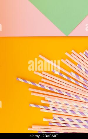 Drinking paper colorful straws for summer cocktails on light pastel background with copy space. Eco friendly Reusable Straws. Paper cocktail tubes Stock Photo