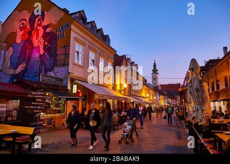 People stroll along Tkalčićeva street passing restaurants and bars in the city of Zagreb, Croatia. Stock Photo