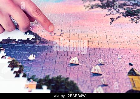 have fun and relax by doing a puzzle Stock Photo
