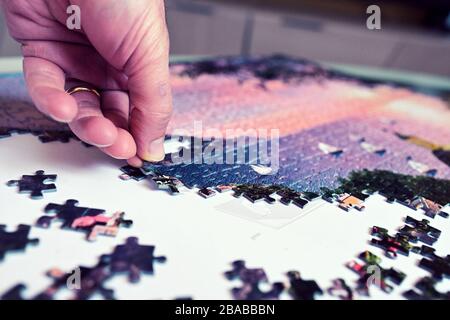 have fun and relax by doing a puzzle Stock Photo