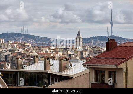 Istanbul, Turkey - February 12, 2020: Residential buildings in the Fatih area with  the Beyoglu district, Galata and TV Tower on Camlica Hill in the b Stock Photo