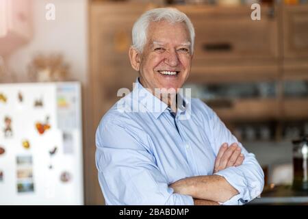 Smiling senior man in his home Stock Photo