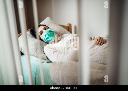Infected woman with mask in mobile quarantine hospital units isolation.Coronavirus patient having pneumonia disease symptoms.Health care.