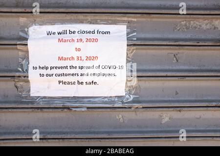 Brooklyn, NY, USA. 26th Mar, 2020. Residents of New York City have been asked to stay home as a result of the novel coronavirus, and all but essential businesses have been asked to close. In Brooklyn's Midwood neighborhood, many businesses have their shutters rolled down, and the few that are open limit the number of people who can enter. A sign on a closed business on Nostrand Avenue. Credit: Ed Lefkowicz/Alamy Live News Stock Photo