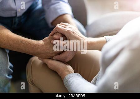 Close up of senior couple holding hands Stock Photo