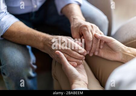 Close up of senior couple holding hands Stock Photo