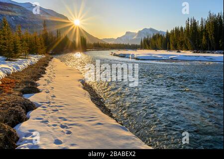 Winter sunrise on the Bow River at Canmore, Alberta, Canada Stock Photo