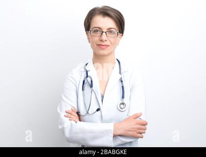 Portrait of a smiling female doctor in lab coat with a stethoscope on a white background. Stock Photo