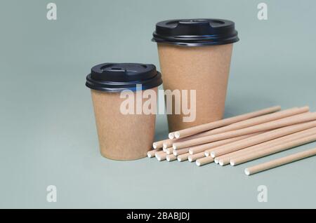 Craft coffee cups with paper straw on gray background. Eco friendly design. Zero waste, plastic free items Stock Photo