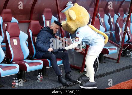 Aston Villa mascot Bella pats the head of Tottenham Hotspur manager Jose Mourinho prior to kick-off, Stock Photo