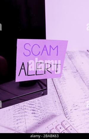 Text sign showing Scam Alert. Business photo showcasing unsolicited email that claims the prospect of a bargain Notation paper taped to black computer Stock Photo