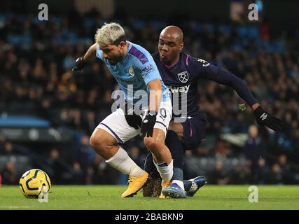 Manchester City's Sergio Aguero (left) and West Ham United's Angelo Ogbonna (right) tangle in the penalty area Stock Photo